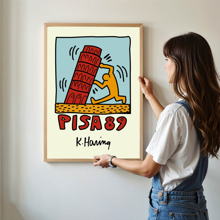 Keith Haring illustration of the Leaning Tower of Pisa with stylized orange figure
